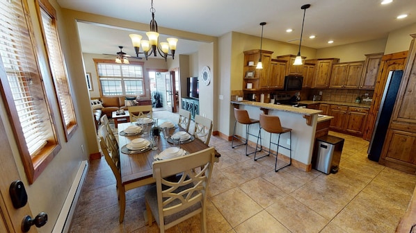 Entryway view of dining area, kitchen, and living room in the background.