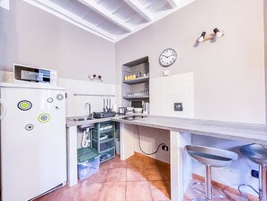 An induction kitchenette, complete with all necessities and also equipped with microwave and kettle. 