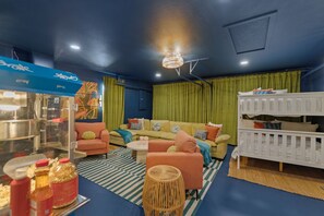 The movie theater room also has a queen bunk bed and plenty of seating