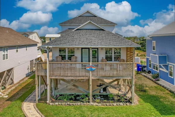 Front view of Dolphin Delight with a large porch located only 2 blocks from the ocean