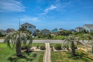 What a beautiful view of the landscaped front yard from the front deck. Looking South towards the ocean .