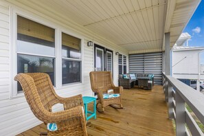 Enjoy the Large Front Deck. Plenty of seating & a slatted end to keep the porch cooler. The spot for morning coffee & evening beverages.