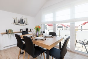 Large table with chairs for eating communal meals. 