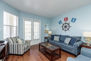 Living area with plenty of natural light shinning in and private balcony to enjoy