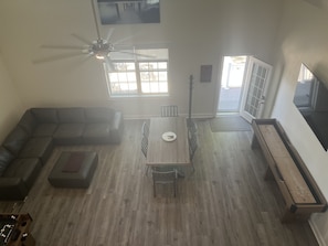 Large open concept living with shuffleboard, fuseball, 75” TV with cable.