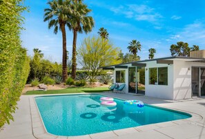 Enjoy a beautiful pool area surrounded by a vibrant desert garden