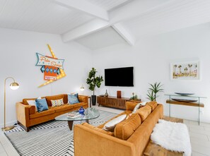 Find comfort in the living room with 2 inviting sofas & a 63" Roku TV