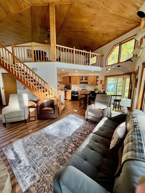 Main indoor gathering area off kitchen with lofted ceiling, Smart TV, big views.