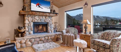 Main Living Room with a wood-burning fireplace, smart tv, and fabulous mountain views