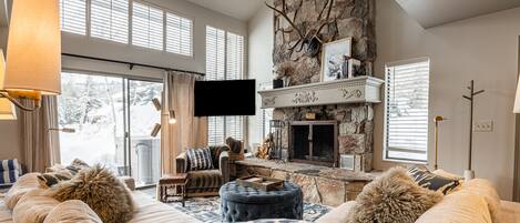 Living Room with Smart TV, gas-assist fireplace, and private hot tub patio access