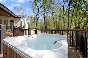 Hot Tub Oasis: Unwind in the inviting hot tub surrounded by nature’s serene beauty!