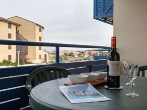 Tableware, Property, Furniture, Table, Bottle, Sky, Window, Blue, Building, Drinkware