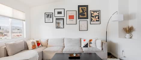 Living Room // Large entertainment space with boardgames, books, and a Smart TV