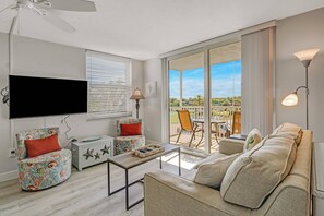 Sliding glass doors open to the fully screened lanai and flood the space with Florida sunlight.