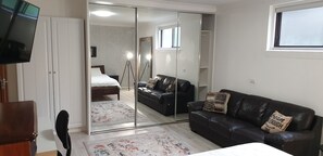 Bedroom has a large mirror wardrobe 55" smart TV Leather couch come second bed