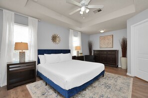 King bedroom with smart TV and dresser