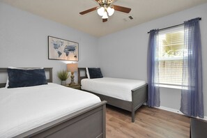 Bedroom with 2 single or twin beds a walk-in closet, hangers and smart TV  