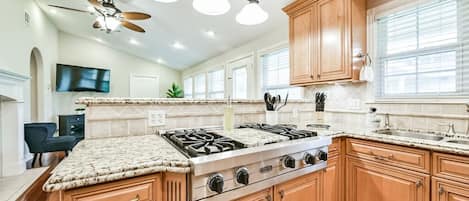 Full kitchen with extra amenities, bar dining seats 4, and living area.