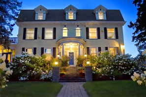 View of the mansion from the street at dusk