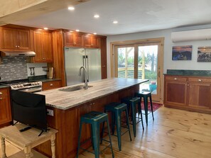 Kitchen with island, oversized fridge, and freezer