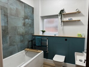 Family bathroom with shower over bath