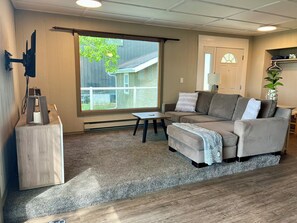 Cozy living room area, comfy couch, tv w/firestick, dvds, games & cards