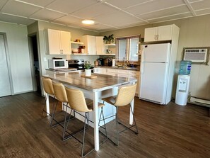 Kitchen + island w/seating. Fully stocked with all kitchen-ware you need!