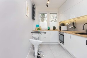 Functional kitchen with white cabinets and quality appliances that allow you to prepare home-cooked meals.