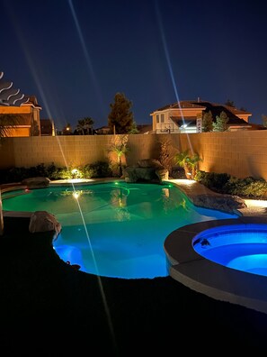 Nighttime pool & jacuzzi 