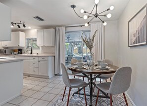 Four person dining room table with bright, sputnik chandelier overhead!