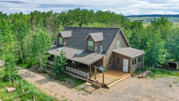 Heart of the Aspens home is nestled in an aspen grove, with acres of land surrounding the house.