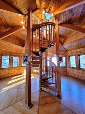 Spectacular wooden spiral staircase in the three story "tower"