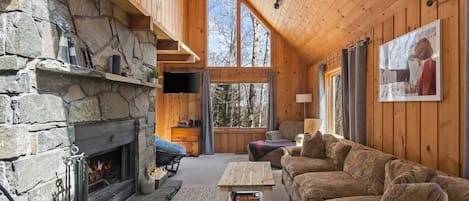 Spacious living room with fireplace and large windows for great natural light.