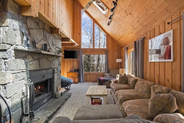 Spacious living room with fireplace and large windows for great natural light.