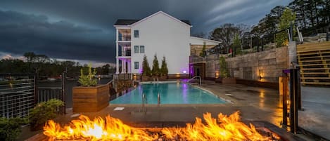 This stunning property features shared areas, including this fairy tale fire pit with surrounding seating, infinity pool, and lounge chairs.