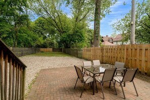 Step out onto the brick patio, where comfort meets charm. With a stylish table, comfy chairs, and a BBQ grill ready to go, it's the perfect spot for morning coffee, sunset dinners, or sizzling up something special under the open sky.
