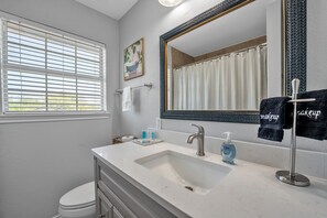 Wash up in the central bathroom with a relaxing tub and overhead shower