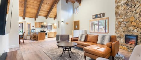 Open concept living w/vaulted ceilings, sectional, smart TV, electric fireplace.