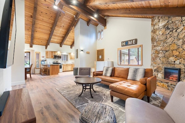 Open concept living w/vaulted ceilings, sectional, smart TV, electric fireplace.