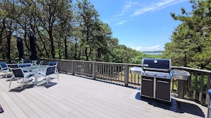 Large deck with gas grill and tables and chairs