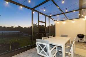 Unwind on the private patio, complete with comfortable seating and a dining area perfect for enjoying outdoor meals and soaking up the fresh air.