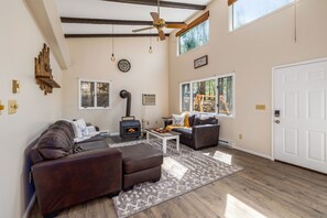 Grand hall with Vaulted Ceiling and a decorative rustic woodburning fireplace