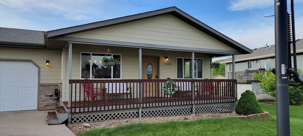 Front view featuring covered porch and two stall garage