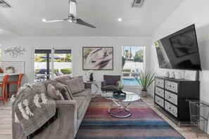 Living room with direct access to the outdoor pool area, perfect for entertaining or a cozy night in.
