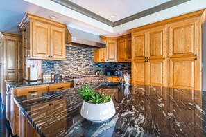 Arouse your inner chef in the epicurean kitchen, with spacious island carved from obsidian marble...
