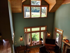 High ceilings and tall windows frame the trees outsid