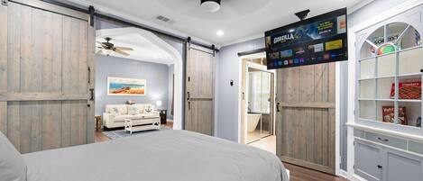 Master bedroom has barn doors and smart TV