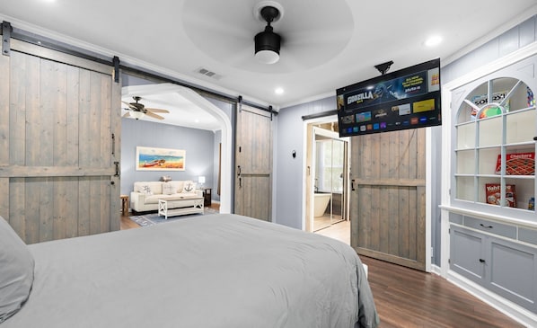 Master bedroom has barn doors and smart TV