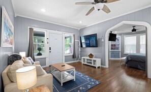 Living room looking into master bedroom-smart TVs throughout