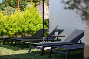 Garden area, relaxing sunbeds in Stone Project villa, Pigi Rethymno